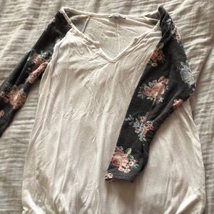 White top with floral arm design, slight v neck